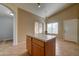 Kitchen with island, light tile flooring, and door to backyard at 3128 E Millbrae Ln, Gilbert, AZ 85234