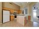 Spacious kitchen with island, wood cabinets, and tile flooring at 3128 E Millbrae Ln, Gilbert, AZ 85234