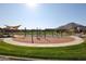 Community playground with play structures and swings for  at 34475 N Fortini Way, Queen Creek, AZ 85144