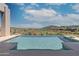 Infinity pool overlooking a golf course and mountain views at 15332 E Hidden Springs Trl, Fountain Hills, AZ 85268