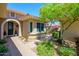 Charming courtyard entry with a pathway and lush desert landscaping at 17226 W Calistoga Dr, Surprise, AZ 85387