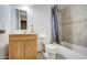 Bathroom with a shower/tub combo, toilet and wooden vanity at 6842 W Devonshire Ave, Phoenix, AZ 85033