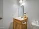 Bathroom with a toilet and wooden vanity at 6842 W Devonshire Ave, Phoenix, AZ 85033