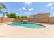 Inviting kidney-shaped pool with a waterfall feature at 11543 E Quade Ave, Mesa, AZ 85212