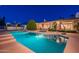 Stunning nighttime view of a refreshing pool and backyard oasis at 10512 E Cortez Dr, Scottsdale, AZ 85259