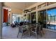 Covered patio with seating area, glass doors, and ceiling fan at 10512 E Cortez Dr, Scottsdale, AZ 85259
