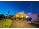 Evening view of home's exterior with landscaping and pathway at 10512 E Cortez Dr, Scottsdale, AZ 85259