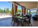 Covered patio with seating area, dining table, and view of the pool and backyard at 10512 E Cortez Dr, Scottsdale, AZ 85259