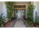 Front entry with decorative door and potted plants at 10512 E Cortez Dr, Scottsdale, AZ 85259