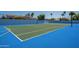 Private lighted tennis court with blue and green surface at 10512 E Cortez Dr, Scottsdale, AZ 85259