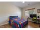 Cozy bedroom with a comfortable bed and a workspace at 10512 E Cortez Dr, Scottsdale, AZ 85259