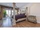 Primary bedroom with large bed, hardwood floors and private access at 10512 E Cortez Dr, Scottsdale, AZ 85259