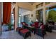 Relaxing patio furniture with red cushions near the pool and sliding glass doors at 10512 E Cortez Dr, Scottsdale, AZ 85259