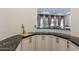 Wet bar with dark granite countertop and custom cabinetry at 10512 E Cortez Dr, Scottsdale, AZ 85259