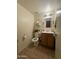 Clean bathroom with wood vanity and tiled floor at 4255 N 67Th Ln, Phoenix, AZ 85033