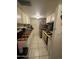 Galley kitchen features tiled countertops and stainless steel appliances at 4255 N 67Th Ln, Phoenix, AZ 85033