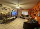 Spacious living room featuring a large TV and sectional sofa at 4255 N 67Th Ln, Phoenix, AZ 85033