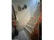 Indoor staircase with white tile and metal railing at 4255 N 67Th Ln, Phoenix, AZ 85033