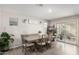 Bright dining room with wooden table and chairs near sliding glass doors at 16256 W La Ventilla Way, Goodyear, AZ 85338