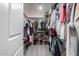 Large walk-in closet with ample shelving and hanging space at 16256 W La Ventilla Way, Goodyear, AZ 85338