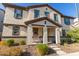 Two-story house with covered porch and a bench at 16256 W La Ventilla Way, Goodyear, AZ 85338