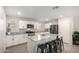 Modern kitchen with white cabinets, granite countertops, and island at 16256 W La Ventilla Way, Goodyear, AZ 85338