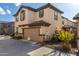 Two-story house with beige stucco, brown accents, and a two-car garage at 16256 W La Ventilla Way, Goodyear, AZ 85338