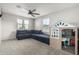 Spacious playroom with a large sectional sofa and playhouse at 16256 W La Ventilla Way, Goodyear, AZ 85338