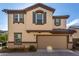 Two story house with tan exterior and two car garage at 16256 W La Ventilla Way, Goodyear, AZ 85338