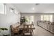 Dining area with a wood table and bench, and access to the backyard at 16256 W La Ventilla Way, Goodyear, AZ 85338