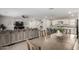 Kitchen and dining area with an island, hardwood floors and white cabinets at 16256 W La Ventilla Way, Goodyear, AZ 85338