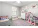 bedroom with playful decor, built-in shelving, and a comfortable bed at 16256 W La Ventilla Way, Goodyear, AZ 85338