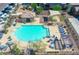 Community pool with surrounding lounge chairs and tables at 16256 W La Ventilla Way, Goodyear, AZ 85338