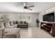 Open living area with a large gray sectional sofa and wood-look floors at 16256 W La Ventilla Way, Goodyear, AZ 85338