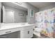 Bathroom with white vanity, mermaid-themed shower curtain, and toilet at 16256 W La Ventilla Way, Goodyear, AZ 85338