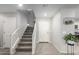 Gray carpeted staircase with a white door at the top at 16256 W La Ventilla Way, Goodyear, AZ 85338