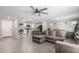 Open living room with gray sectional sofa and kitchen view at 16256 W La Ventilla Way, Goodyear, AZ 85338