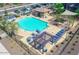 Community pool area with lounge chairs, tables, and pergola at 16256 W La Ventilla Way, Goodyear, AZ 85338
