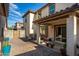 Spacious backyard patio with seating area and covered porch at 16256 W La Ventilla Way, Goodyear, AZ 85338