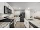 Modern kitchen with stainless steel appliances and granite countertops at 16256 W La Ventilla Way, Goodyear, AZ 85338