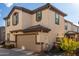 Two-story house with beige stucco, brown accents, and a two-car garage at 16256 W La Ventilla Way, Goodyear, AZ 85338