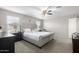 Main bedroom with a king-size bed and ceiling fan at 16256 W La Ventilla Way, Goodyear, AZ 85338