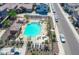Aerial view of community pool with lounge chairs and tables at 16256 W La Ventilla Way, Goodyear, AZ 85338