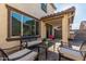 Relaxing backyard patio with seating area and view of the home at 16256 W La Ventilla Way, Goodyear, AZ 85338