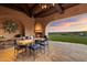 Outdoor dining patio with mountain views and a fireplace at 10719 E Rimrock Dr, Scottsdale, AZ 85255