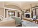 Luxurious main bedroom with fireplace and private access to outdoor space at 10719 E Rimrock Dr, Scottsdale, AZ 85255
