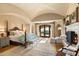 Main bedroom suite with fireplace, sitting area, and French doors to a patio at 10719 E Rimrock Dr, Scottsdale, AZ 85255