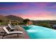 Expansive infinity pool with mountain and city views at 10719 E Rimrock Dr, Scottsdale, AZ 85255