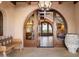 Grand entryway with arched doorways and a large pot at 10719 E Rimrock Dr, Scottsdale, AZ 85255
