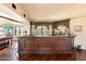 Elegant home bar with dark wood cabinetry and a granite countertop at 10719 E Rimrock Dr, Scottsdale, AZ 85255